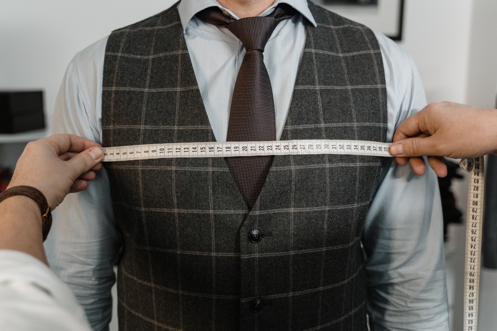 Tailor Measuring a Client's Chest